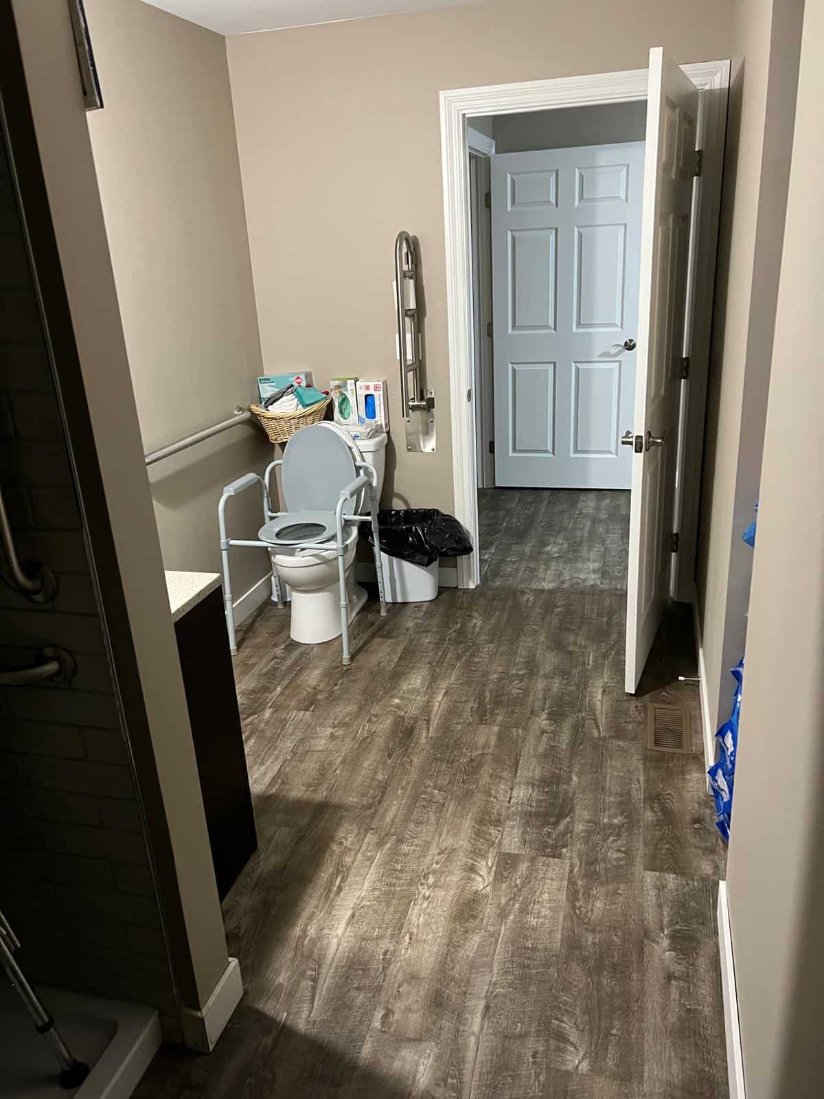 View from accessible bathroom into the wide, well-lit hallway — part of 1st Blessed AFH's step-free layout
