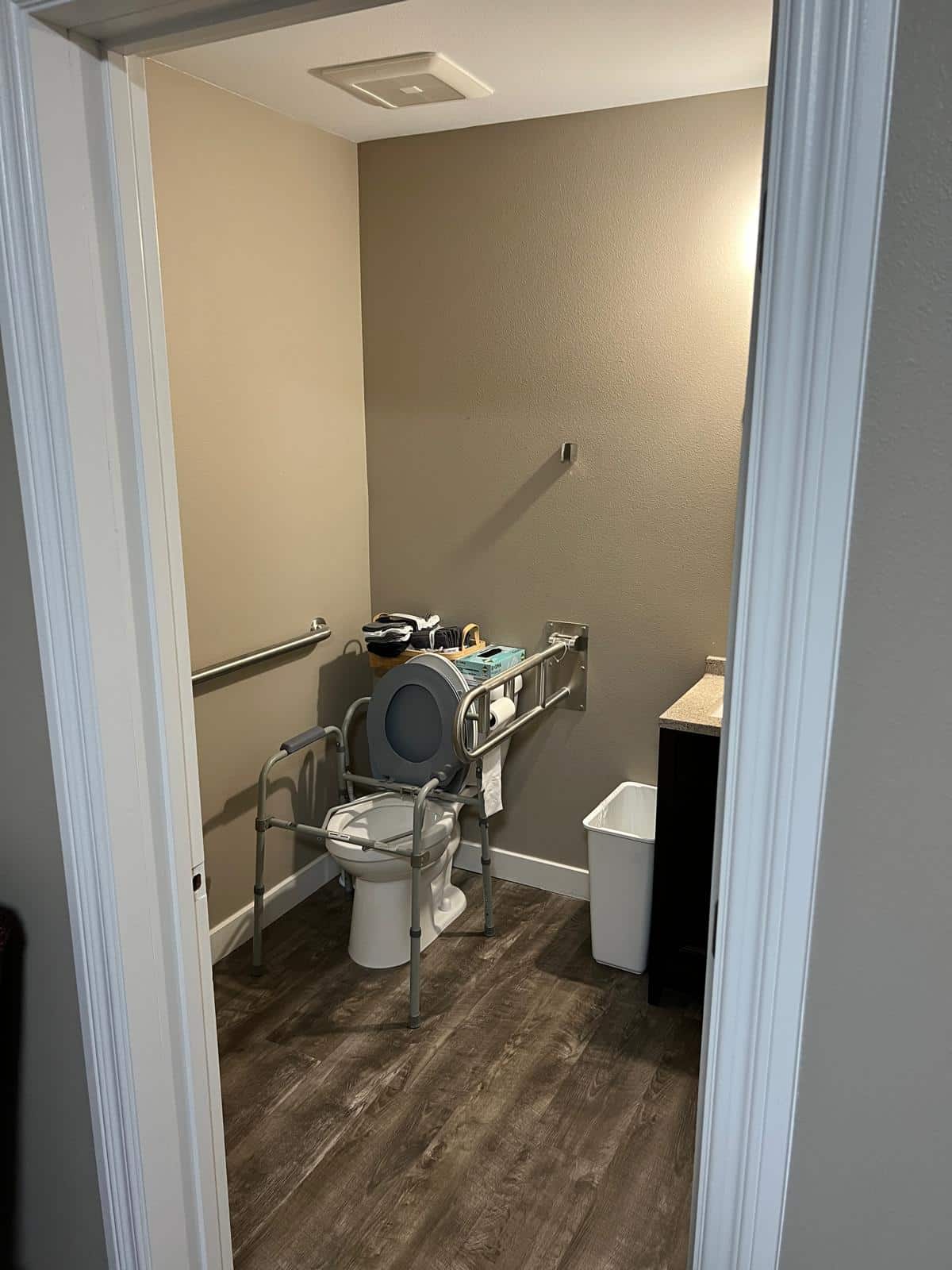 Clean guest bathroom with accessibility features, available to residents and visiting family members